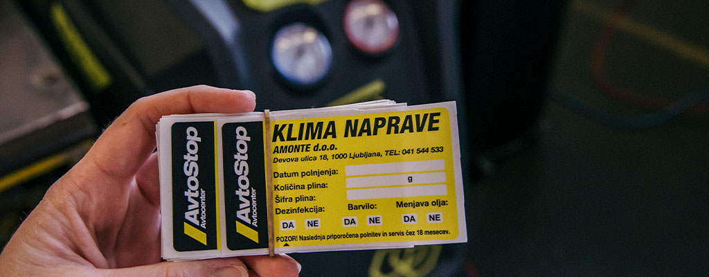 Na fotografiji je nalepka, ki dokazuje, da bila klima v avtu servisirana.